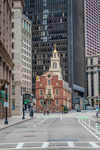 Road amidst buildings in city