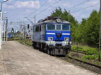 Train on railroad track against sky