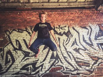 Man standing on brick wall