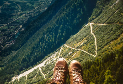 Low section of man standing on mountain