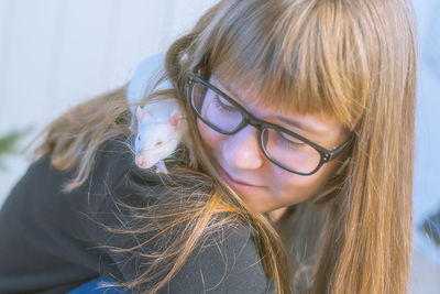 Close-up of smiling girl with rat