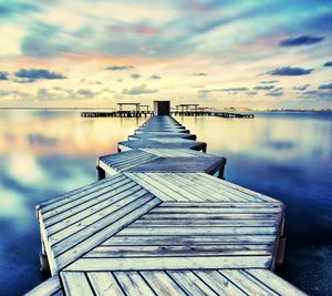 Pier over lake against sky