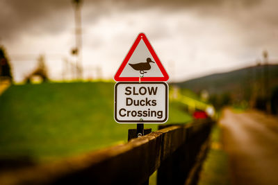 Bokeh of a road sign warning to watch out for ducks and ducklings crossing the road