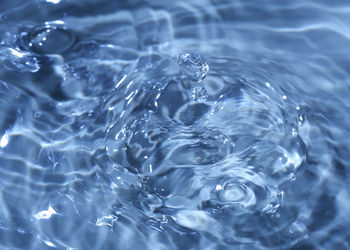 High angle view of drop falling in swimming pool