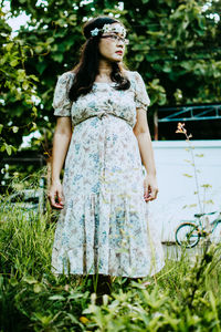 Young woman standing on grass