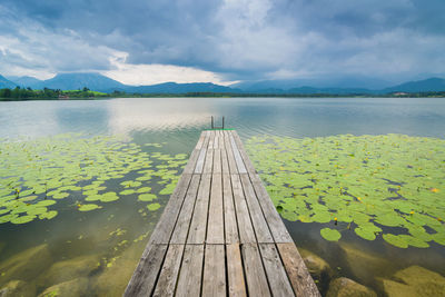 Pier over lake against sky