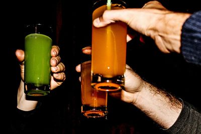 Close-up of man toasting with drinks