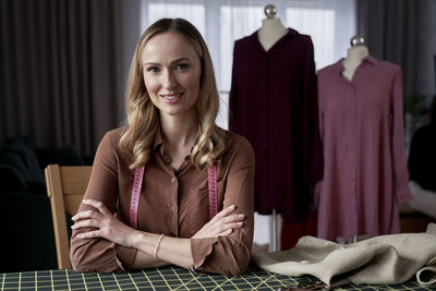 Portrait of young woman using laptop at home
