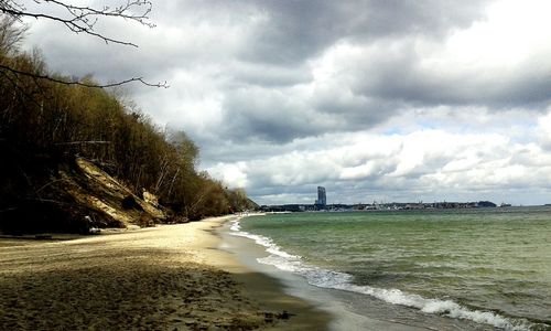 Scenic view of sea against storm clouds