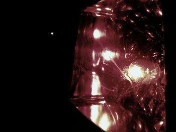 Reflection of illuminated lights in puddle