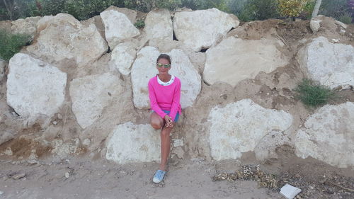 Portrait of woman standing on rock