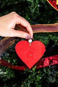 Close-up of hand holding red heart