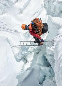 Nepal, solo khumbu, everest, sagamartha national park, mountaineer crossing icefall at western cwm