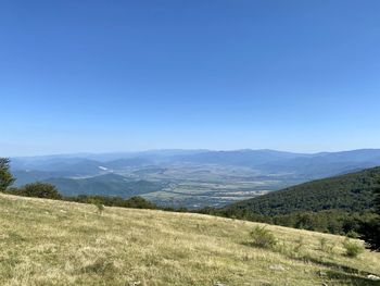 Scenic view of landscape against clear blue sky