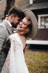 Happy couple standing on field