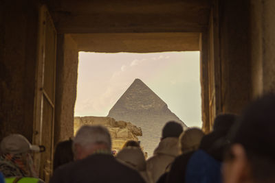 Rear view of woman standing in tunnel