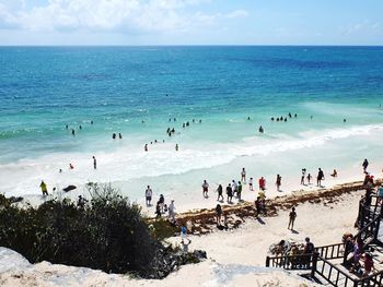 People on beach against sky