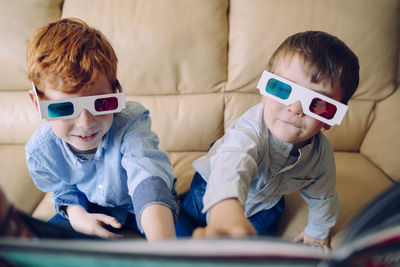 Boys sitting on sofa at home