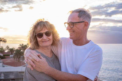 Portrait of young woman wearing sunglasses against sea