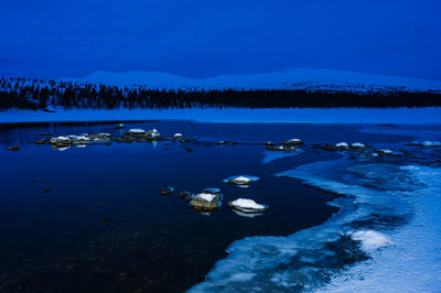 Ice at still lake in early morning