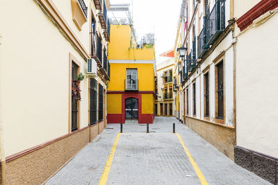 Empty alley amidst buildings in city