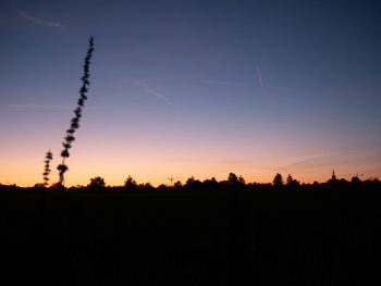 Silhouette landscape against sky during sunset