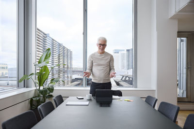 Businessman having video call in boardroom