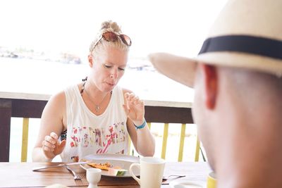 Woman eating food at restaurant