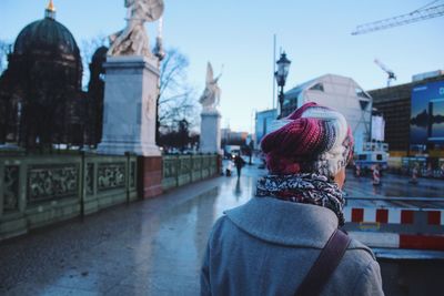 Rear view of woman with buildings in background