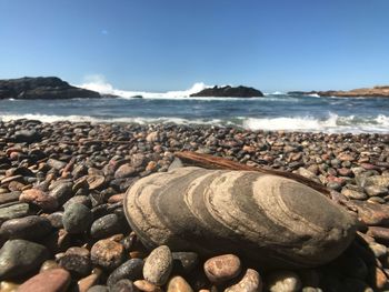 Rocks on beach against sky