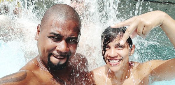 Portrait of couple enjoying in swimming pool