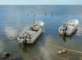 High angle view of fishing boats in sea against sky