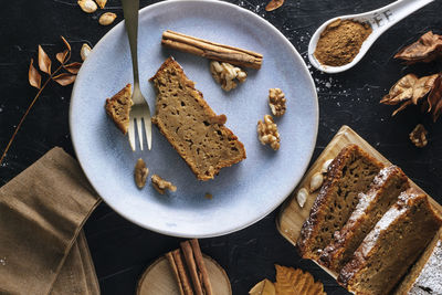 A slice of pumpkin sponge cake on a blue plate