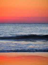 Scenic view of sea against orange sky