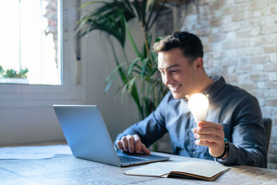 Young woman using laptop at home