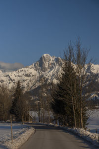 Scenic view of snowcapped mountains against clear blue sky