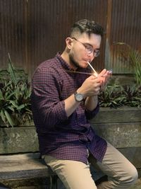 Young man smoking cigarette