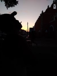 Silhouette man against sky at sunset