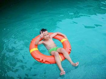 High angle view of boy swimming in pool