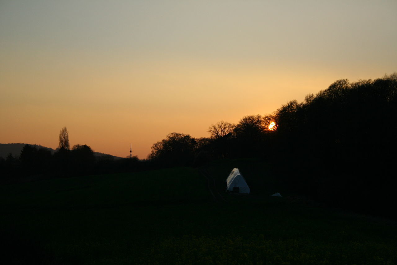 SILHOUETTE OF TENT ON LANDSCAPE AGAINST SKY