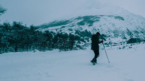 Full length of person skiing on snowcapped field