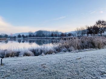 Scenic view of frozen lake against sky during winter