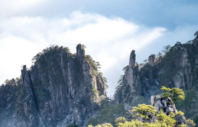 Low angle view of rock formation on mountain against sky