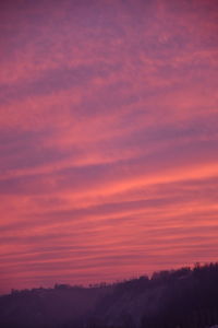 Scenic view of silhouette landscape against sky at sunset