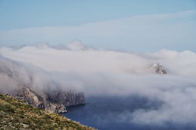 Scenic view of sea and mountains against sky