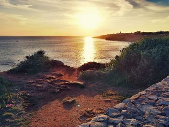 Scenic view of beach against sky during sunset