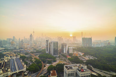 High angle view of buildings in city during sunset