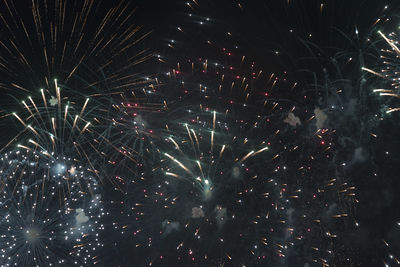 Low angle view of firework display at night