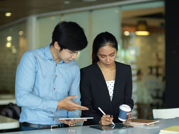 Cheerful colleagues having discussion at office