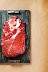 Top view of beef meat on wooden tray with copy space